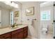 Tastefully designed bathroom with a granite countertop, a framed mirror, and access to the toilet at 655 Grove Manor Ct, Suwanee, GA 30024