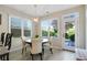 Bright breakfast nook featuring a round table, pendant lighting, and views of the landscaped backyard at 655 Grove Manor Ct, Suwanee, GA 30024