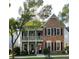 Charming two-story home with brick and siding, complemented by a cozy balcony and manicured lawn at 655 Grove Manor Ct, Suwanee, GA 30024