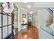 Bright foyer featuring hardwood floors and staircase, creating an inviting entry at 655 Grove Manor Ct, Suwanee, GA 30024