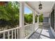 Charming front porch with white columns and railings, plus a hanging flower basket at 655 Grove Manor Ct, Suwanee, GA 30024