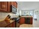 Gourmet kitchen featuring stainless steel appliances, granite countertops, and tile backsplash at 655 Grove Manor Ct, Suwanee, GA 30024