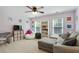 Bright living room space featuring modern furniture, lots of natural light, and a playful setup at 655 Grove Manor Ct, Suwanee, GA 30024