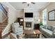 Comfortable living room showcasing a stone fireplace, plush seating, and elegant decor at 655 Grove Manor Ct, Suwanee, GA 30024