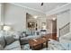 Bright and airy living room with hardwood floors and a view into the dining area at 655 Grove Manor Ct, Suwanee, GA 30024