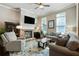 Cozy living room featuring a stone fireplace and comfortable seating area at 655 Grove Manor Ct, Suwanee, GA 30024