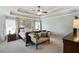 Serene main bedroom with tray ceiling, decorative accents, sitting area, and bright windows at 655 Grove Manor Ct, Suwanee, GA 30024