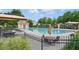 Community pool with lounge chairs and umbrellas, perfect for relaxation and recreation at 655 Grove Manor Ct, Suwanee, GA 30024