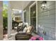 Inviting porch with comfortable wicker furniture, plants, and stylish address plaque at 655 Grove Manor Ct, Suwanee, GA 30024
