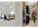 Well-organized walk-in closet with custom shelving, rods, and shoe racks, plus bedroom sitting area at 655 Grove Manor Ct, Suwanee, GA 30024