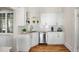 Bright butler pantry featuring white cabinets, open shelves, and stainless steel dishwasher at 1050 Lawton Sw Ave, Atlanta, GA 30310