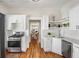 Beautiful kitchen featuring modern appliances, white cabinets, hardwood floors and an open design at 1050 Lawton Sw Ave, Atlanta, GA 30310