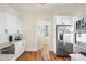Well-lit kitchen featuring white cabinets, stainless steel appliances, and hardwood floors at 1050 Lawton Sw Ave, Atlanta, GA 30310