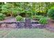 Tiered backyard features landscaping and a stairway to a wooded area at 1500 Highland Farm Dr, Suwanee, GA 30024