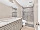Updated bathroom with double sinks, tile floors, and a glass-enclosed shower at 1500 Highland Farm Dr, Suwanee, GA 30024