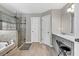 Bathroom featuring a tub, a glass door shower and white cabinets at 1500 Highland Farm Dr, Suwanee, GA 30024