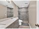 Updated bathroom with double sinks, tile floors, and a glass-enclosed shower at 1500 Highland Farm Dr, Suwanee, GA 30024