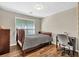 Comfortable bedroom featuring a window, wood floors and a ceiling light at 1500 Highland Farm Dr, Suwanee, GA 30024