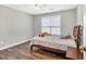 Cozy bedroom featuring hardwood floors, neutral paint, and a ceiling fan at 1500 Highland Farm Dr, Suwanee, GA 30024