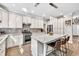 A modern kitchen with granite countertops, stainless appliances, tile backsplash, and a large island at 1500 Highland Farm Dr, Suwanee, GA 30024