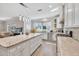 A modern kitchen with granite countertops, stainless appliances, tile backsplash, and a large island at 1500 Highland Farm Dr, Suwanee, GA 30024
