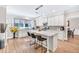 A modern kitchen with granite countertops, stainless appliances, tile backsplash, and a large island at 1500 Highland Farm Dr, Suwanee, GA 30024