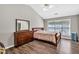 Bright bedroom with hardwood floors, large window, and neutral walls at 1500 Highland Farm Dr, Suwanee, GA 30024