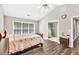 Primary bedroom features hardwood flooring, tray ceilings, and ensuite bathroom access at 1500 Highland Farm Dr, Suwanee, GA 30024
