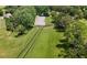 Aerial view of a fenced riding arena, barn, and pasture at 200 Mcclure Dr, Cumming, GA 30028