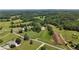 Stunning aerial view of sprawling land with horse paddocks and barn at 200 Mcclure Dr, Cumming, GA 30028