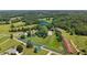 Aerial view of an outlined property including meadows, trees, and outbuildings at 200 Mcclure Dr, Cumming, GA 30028