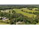 Expansive aerial view of lush land showcasing house nestled amongst the trees at 200 Mcclure Dr, Cumming, GA 30028