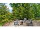 Landscaped backyard patio with outdoor seating and a fire pit for relaxing and entertaining at 200 Mcclure Dr, Cumming, GA 30028