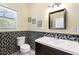Bathroom featuring stylish mosaic tile, large mirror, and updated sink and vanity at 200 Mcclure Dr, Cumming, GA 30028