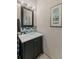 Bathroom features a vanity with glass vessel sink, framed mirror, decorative art, and unique tiled backsplash at 200 Mcclure Dr, Cumming, GA 30028