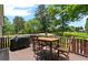 Outdoor deck with metal table set and furniture, providing a tranquil and scenic view at 200 Mcclure Dr, Cumming, GA 30028
