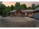 Charming home with a covered porch, stone accents, and a detached two-car garage with ample parking space at 200 Mcclure Dr, Cumming, GA 30028