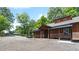 Exterior of a beautiful home featuring a private drive, a wooded lot, and ample parking at 200 Mcclure Dr, Cumming, GA 30028