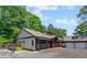 Charming exterior with a detached garage, beautiful porch, and plenty of surrounding greenery at 200 Mcclure Dr, Cumming, GA 30028