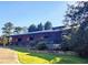 Charming home features a stone foundation, long covered porch and lush landscaping at 200 Mcclure Dr, Cumming, GA 30028
