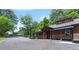 Exterior facade with stone accents, a covered porch, and driveway leading to the right at 200 Mcclure Dr, Cumming, GA 30028
