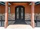 Elegant front entrance featuring a decorative iron door and stone accents, creating a welcoming ambiance at 200 Mcclure Dr, Cumming, GA 30028