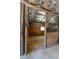 Open horse stall with wood-panel walls, metal bars, and a window for natural light at 200 Mcclure Dr, Cumming, GA 30028