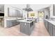 Spacious kitchen with large island, stainless hood, and gray cabinets with white countertops at 200 Mcclure Dr, Cumming, GA 30028