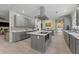 Modern eat-in kitchen boasts stainless appliances, gray cabinets, island, and adjacent dining table at 200 Mcclure Dr, Cumming, GA 30028