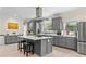 Open-concept kitchen features gray cabinets, stainless steel appliances, and a center island with seating at 200 Mcclure Dr, Cumming, GA 30028
