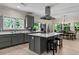 Modern kitchen boasts gray cabinets, stainless steel appliances, and a center island with a white countertop at 200 Mcclure Dr, Cumming, GA 30028