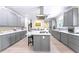 Spacious kitchen with large island, stainless hood, and gray cabinets with white countertops at 200 Mcclure Dr, Cumming, GA 30028