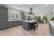 Bright kitchen featuring gray cabinets, stainless steel appliances, an island and adjacent dining table at 200 Mcclure Dr, Cumming, GA 30028
