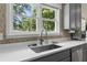 Bright kitchen featuring a stainless steel sink with gooseneck faucet and speckled white countertops at 200 Mcclure Dr, Cumming, GA 30028